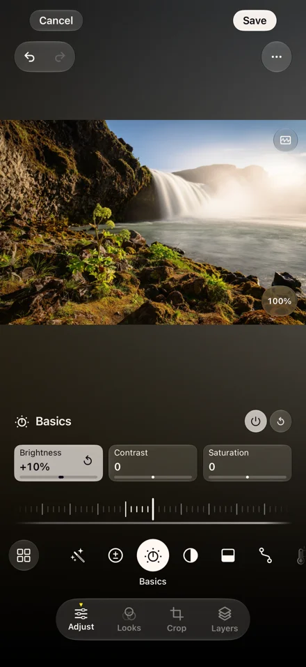 Studio adjusting a waterfall photo, with brightness, contrast, and saturation controls